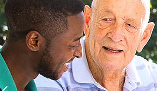 Amana Living - Spencer Park, WA. A resident and his carer outdoors
