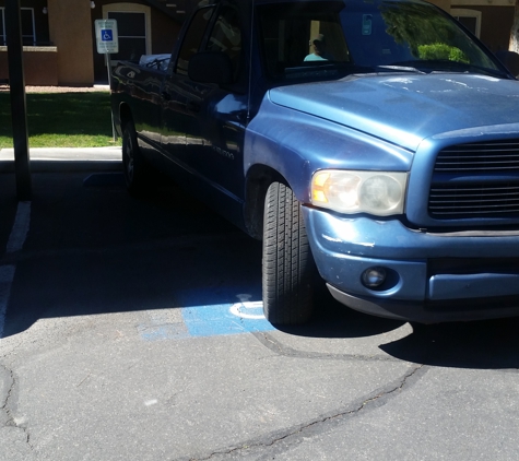 South Valley Apartments - Las Vegas, NV. Maintenance illegally parked in covered handicap for residents.
