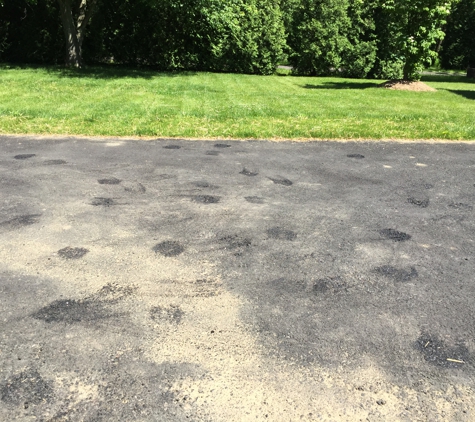 Tom's Sealcoating and Paving. Tire marks because driveway is still soft after 6 months