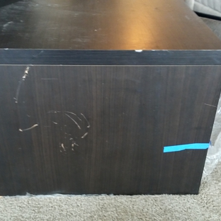 Thompson And Son Moving And Storage - Deerfield Beach, FL. Side of coffee table scratched by other furniture moving around in the truck