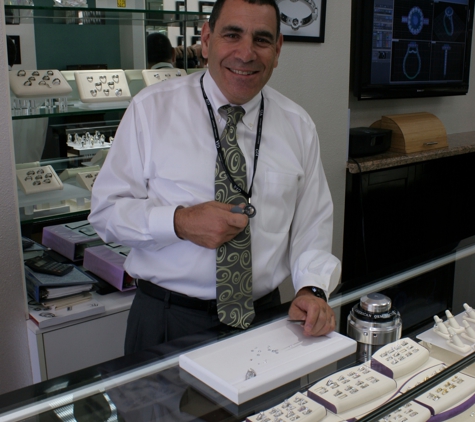 Stuart Benjamin & Co. Jewelry Designs - San Diego, CA. Stuart Benjamin analyzing diamonds and jewelry at the counter.