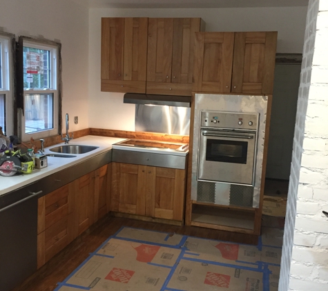 The Detroit Rehab Crew - Detroit, MI. kitchen cabinet, counter, sink, range stove and hood,oven and disher install for BNB. Detroit, MI