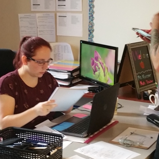 Invictus High School - Cleveland, OH. Invictus teacher looks over students work.