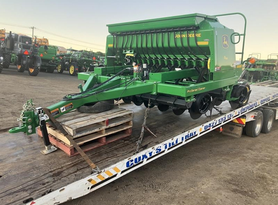 Coxys Tilt Tray and Landscaping Supplies - Bell, QLD. New John Deere1590 10ft Planter being loaded for a 150k move