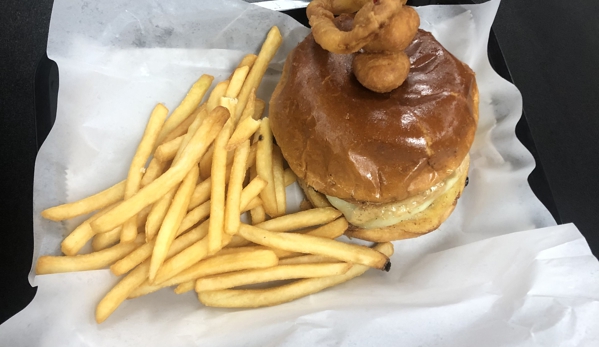 Louie's Char Dogs & Butter Burgers - Milwaukee, WI. Steak Burger with Smoked Brisket, Brie, Swiss , and a Sour Cherry Jam... OMG This is awesome.