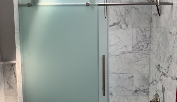 Wesley Home Improvement,LLC - Woodbridge, VA. New Tile installed for shower walls 
New frameless shower door installed