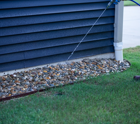 Stonewall Pest Control - Inman, SC. Getting that spray into the soil by the foundation where many pests like to live.