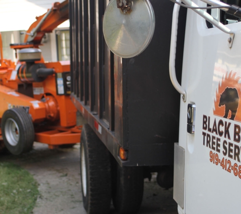 Black Bear Tree Service - Clayton, NC. Service truck with chipper