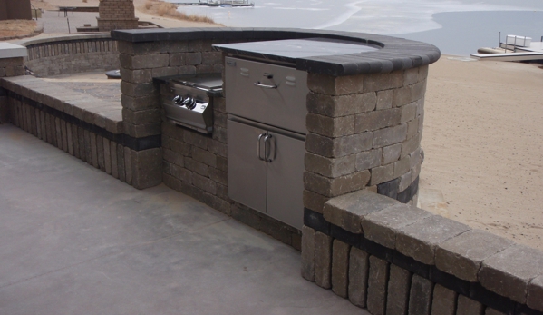 Dreamscapes Inc - Lincoln, NE. Outdoor kitchen at a lake house.  Cooking area was customize to be out of the wind.