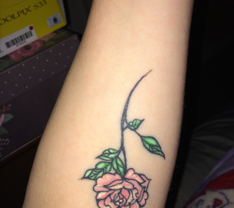 Seven Sins Tattoo - Fresno, CA. Sativa did a wonderful job on my rose. And the environment in the shop is super chill. Everyone is outgoing and sweet! High recommend them!