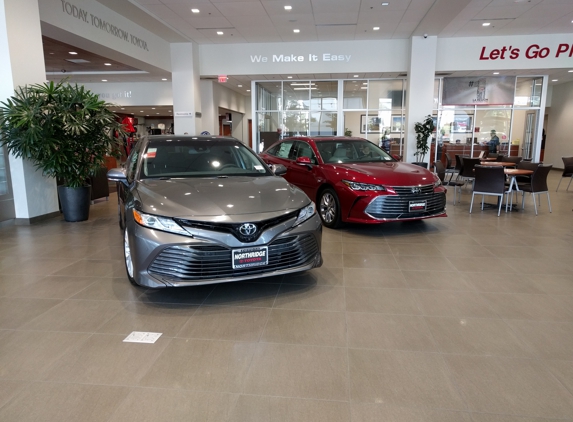 Northridge Toyota - Northridge, CA. 2018 Toyota Camry XLE and a red 2019 Toyota Avalon