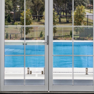 Bradnam's Windows & Doors - Mount St John, QLD. White Aluminium Hinged Door With Colonial Bars