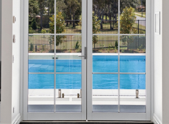 Bradnam's Windows & Doors - Ashmore, QLD. White Aluminium Hinged Door With Colonial Bars