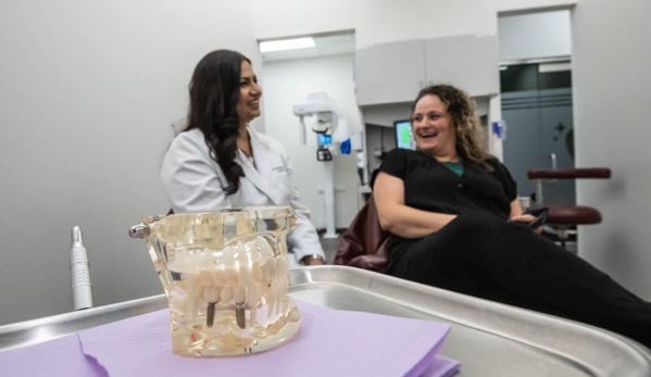 Starlite Dental - Mckinney, TX. McKinney dentist explaining the dental implants procedure to patient at Starlite Dental