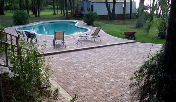 Randy & Ray's LLC - Jacksonville, FL. Spacious step-down patio for this paver pool deck by Randy & Ray's LLC