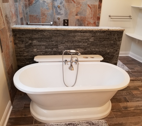 Absolute Interiors and Design, LLC - Cleveland, OH. Stand alone tub with natural stacked stone privacy wall