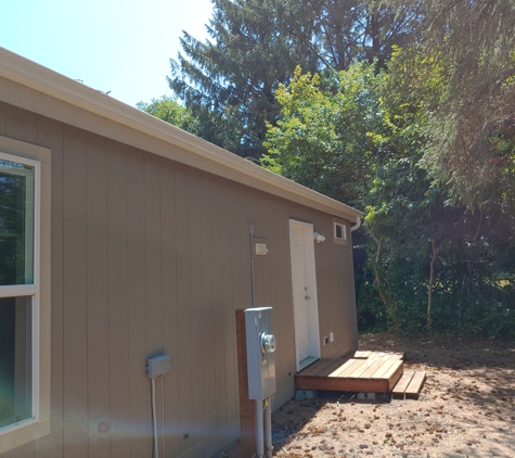 Dr Roof Inc - Long Beach, WA. Side of home showing two windows to be replaced