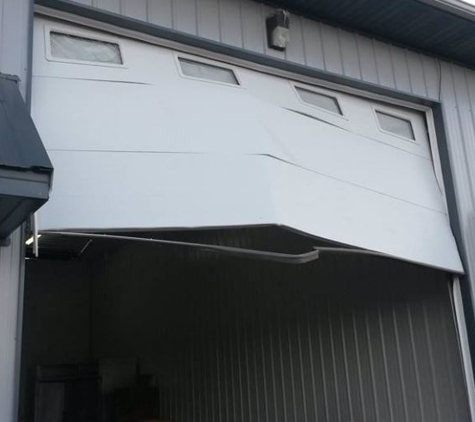 Adams Door Inc. - Cedar Rapids, IA. damaged overhead door