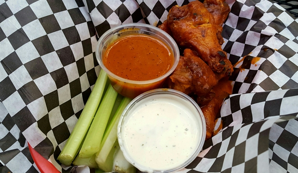 Hooligans - Alpharetta, GA. 5 "Loco Fox" chicken wings with extra sauce, blue cheese, and celery (sauce and celery cost extra).