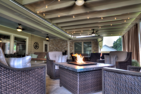 ABC Home Improvements - Baton Rouge, LA. Covered patio with comfortable seating around a fire pit | Custom Patio Cover Arbor in Baton Rouge - www.lasunrooms.com