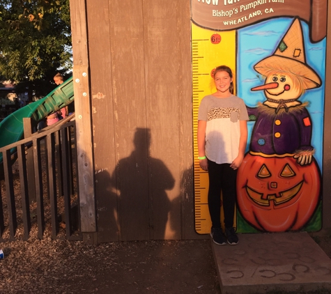 Bishop's Pumpkin Farm - Wheatland, CA. Sara measuring herself, yep she has grown from last year!