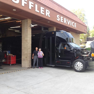 Ed Hanson's Muffler Service - Spring Valley, CA. Owners: Ed Hanson working on 18ft exhaust repair. Marilyn helping customers.