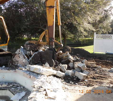 AAA Excavating Svcs., LLC - Cocoa, FL. Loading concrete into Dump Truck for disposal