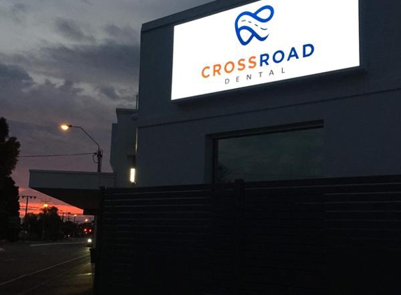 Cross Road Dental Care - South Plympton, SA. Frontage on Cross Road at dusk. Sign illuminated with Cross Road Dental logo