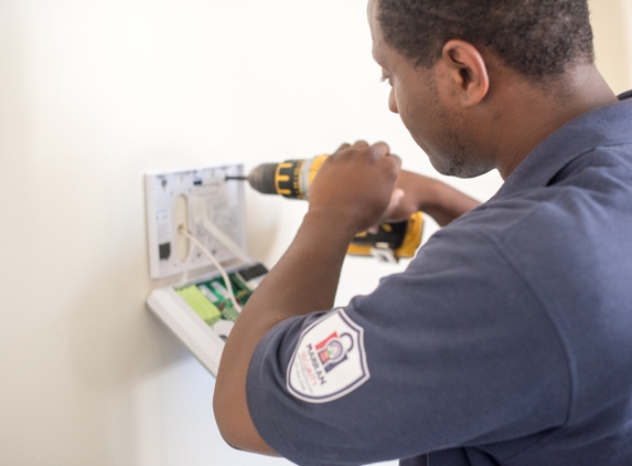 Marran Warmth & Security - Holtsville, NY. A Marran Technician Installs an Alarm Keypad