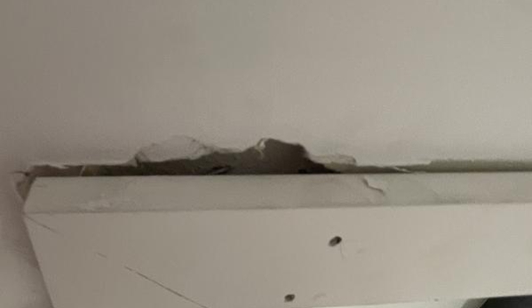 Fallon Solutions. Wall damage 30mm hole above the frame